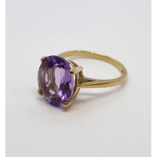 162 - An Amethyst single stone Ring claw-set oval mixed-cut stone in 9ct gold, ring size K1/2, stamped 375... 