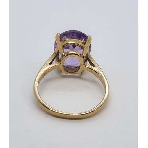 162 - An Amethyst single stone Ring claw-set oval mixed-cut stone in 9ct gold, ring size K1/2, stamped 375... 