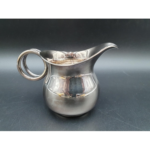 48 - A modern silver designer Milk Jug with double loop handle, Birmingham 2000, maker: AJM, and a silver... 