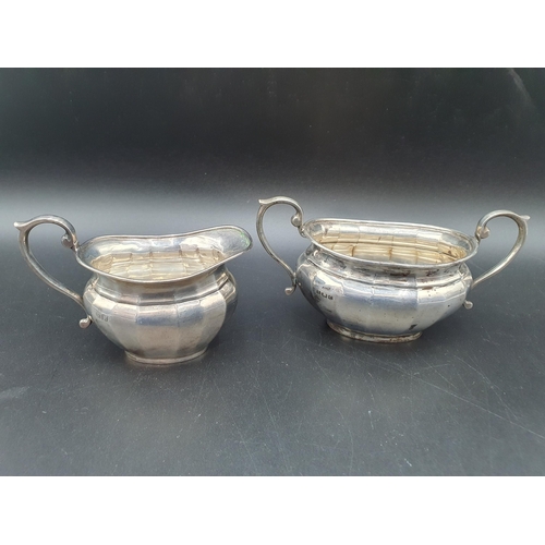 55 - A George V silver two handled Sugar Bowl and Milk Jug of panelled oval form, Birmingham 1926/7, 240g... 