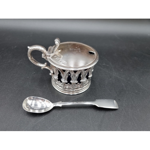 59 - An early Victorian silver Mustard Pot of pierced gothic form, the hinged lid engraved crest, blue gl... 