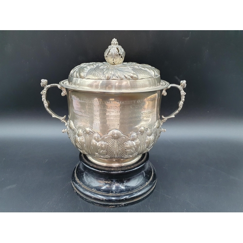 6 - A George V silver two handled Porringer and Cover with leafage embossed and chased friezes, caryatid... 