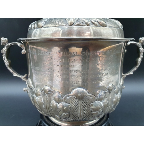 6 - A George V silver two handled Porringer and Cover with leafage embossed and chased friezes, caryatid... 