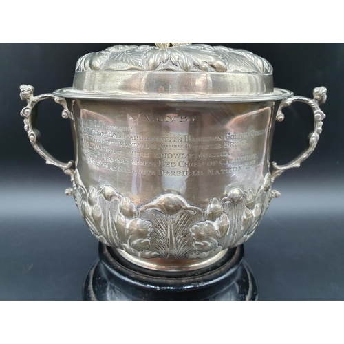 6 - A George V silver two handled Porringer and Cover with leafage embossed and chased friezes, caryatid... 