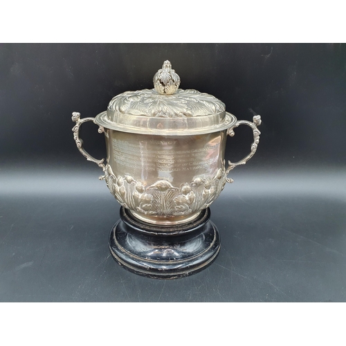 6 - A George V silver two handled Porringer and Cover with leafage embossed and chased friezes, caryatid... 