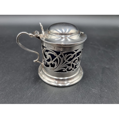 61 - An Edward VII silver pierced Drum Mustard Pot with domed lid, blue glass liner, Sheffield 1902, and ... 