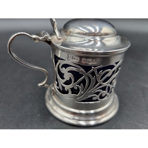 61 - An Edward VII silver pierced Drum Mustard Pot with domed lid, blue glass liner, Sheffield 1902, and ... 