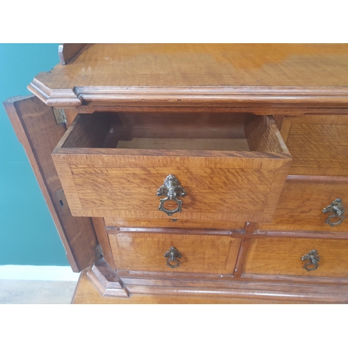 An Aesthetic movement oak with chamfered corners, the upper