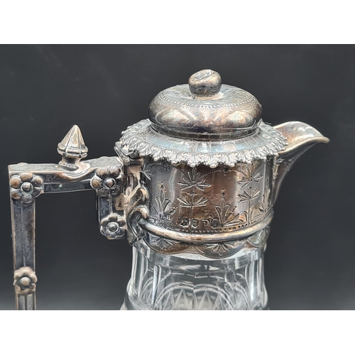 8 - A Victorian silver mounted and lidded cut glass Claret Jug with leafage engraved frieze, mask finial... 