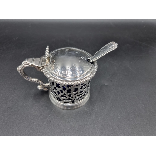 80 - A Victorian silver pieced Drum Mustard Pot with lobed rim, engraved crest, ornate thumb piece, blue ... 