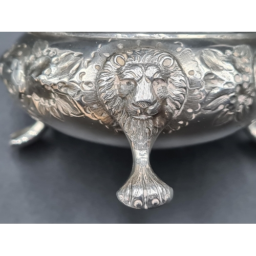 88 - A pair of Victorian silver Cauldron Salts with floral embossing and engraved crests on lion mask and... 