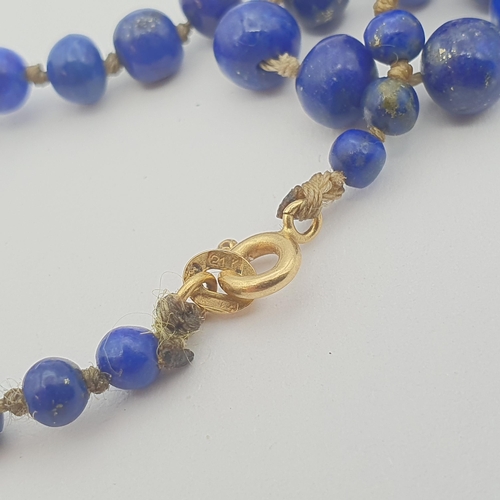 158 - A string of graduated Lapis Lazuli Beads the front with gold bead spacers, clasp marked 21K