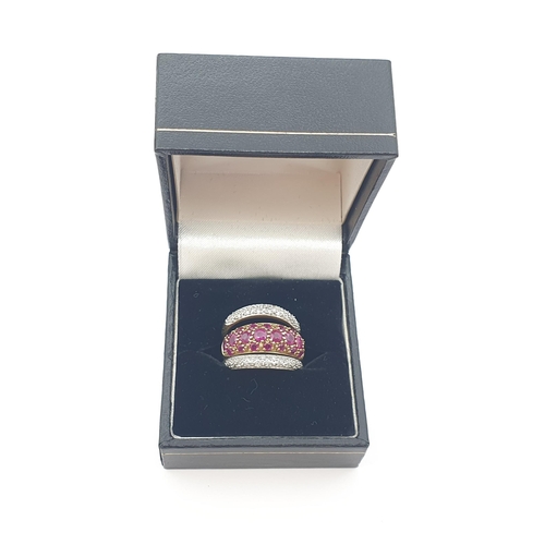 167 - A bombé Ruby Ring peg-set round stones in 9ct gold, ring size K 1/2 and two Diamond Rings in the sam... 