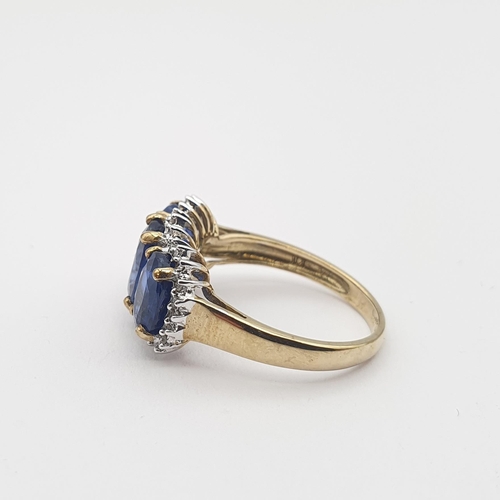 173 - A synthetic Sapphire and Diamond triple Cluster Ring claw-set three oval-cut sapphires within a fram... 