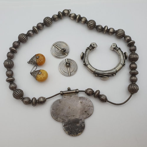 183 - An Indian silver Necklace with red enamel to front plaque, a heavy Bangle and two pairs of Earrings