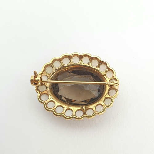 198 - A Smoky Quartz and Cultured Pearl Brooch claw-set oval-cut quartz within a frame of cultured pearls,... 