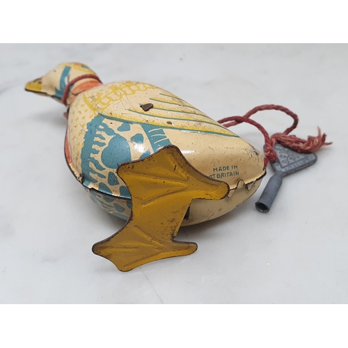 4 - A tinplate clockwork Duck stamped 'Made in Great Britain', a clockwork Goldfinch, a plastic clockwor... 