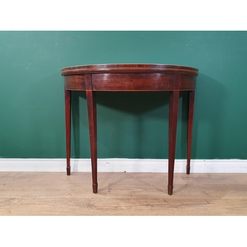 41 - A 19th Century mahogany and satinwood strung demi-lune fold over Tea Table on square tapering suppor... 