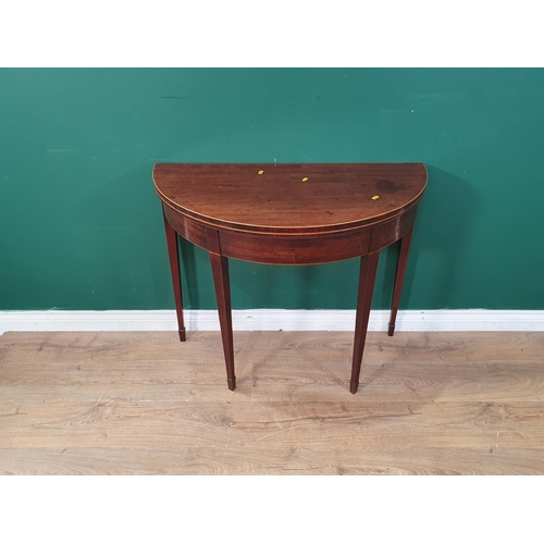 41 - A 19th Century mahogany and satinwood strung demi-lune fold over Tea Table on square tapering suppor... 