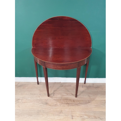 41 - A 19th Century mahogany and satinwood strung demi-lune fold over Tea Table on square tapering suppor... 