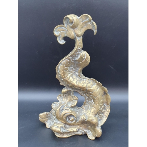 55 - A brass Door Stop in the form of a dolphin, 14in
