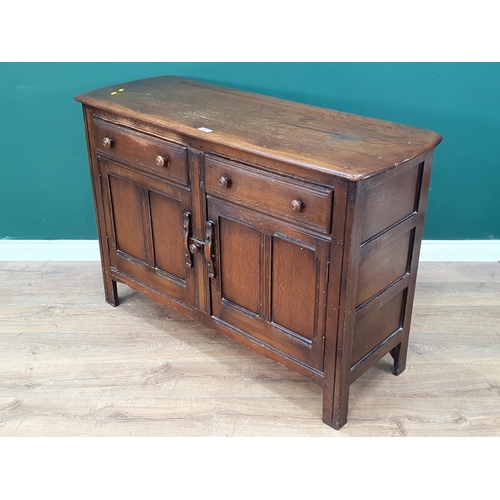 558 - An Ercol dark elm Sideboard with two fitted drawers above pair of panelled doors, 33