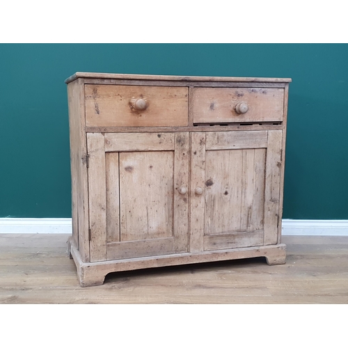 560 - A 19th Century pine Cupboard fitted two frieze drawers above pair of cupboard doors on bracket feet ... 