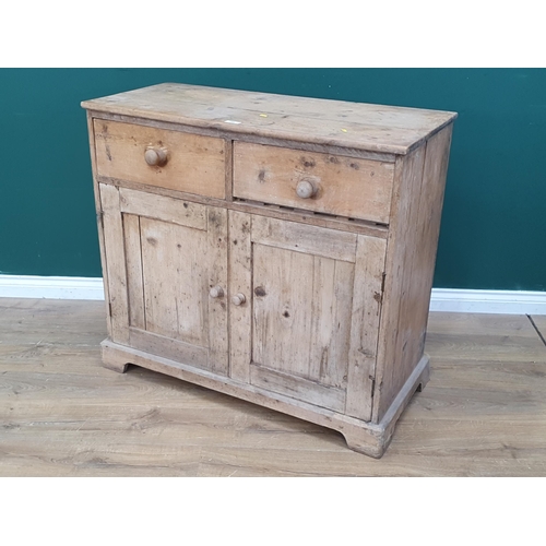 560 - A 19th Century pine Cupboard fitted two frieze drawers above pair of cupboard doors on bracket feet ... 