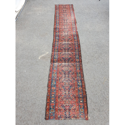 592 - A Persian style Runner cut into two on red ground with multi borders and all over floral decorations... 