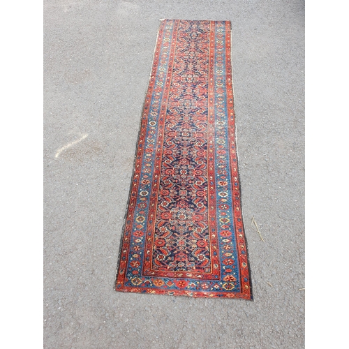 592 - A Persian style Runner cut into two on red ground with multi borders and all over floral decorations... 