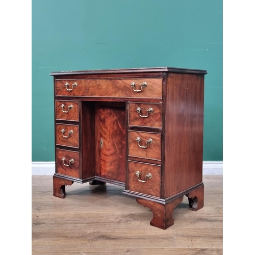 593 - A reproduction mahogany Kneehole Desk, the top with green and gilt inset writing surface, above long... 