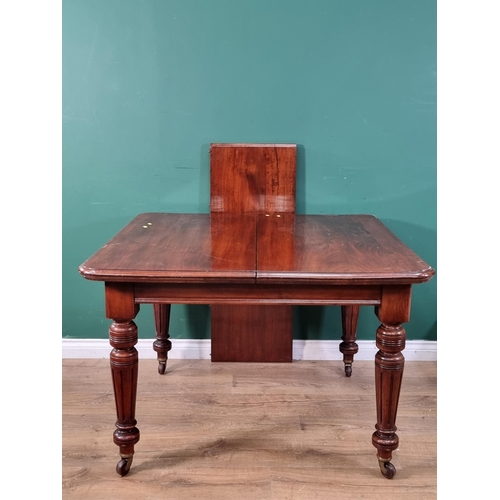 597 - A Victorian mahogany extending Dining Table on reeded turned supports and casters with spare leaf 4f... 