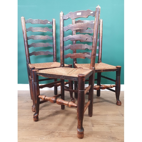 71 - A set of three Yorkshire ash ladderback Dining Chairs with rush seats on turned supports, (R10)