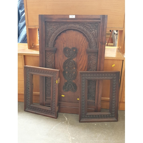 72 - A pair of walnut carved Frames, 17in x 13in, and an antique carved oak Door Panel, 2ft 10in x 1ft 10... 