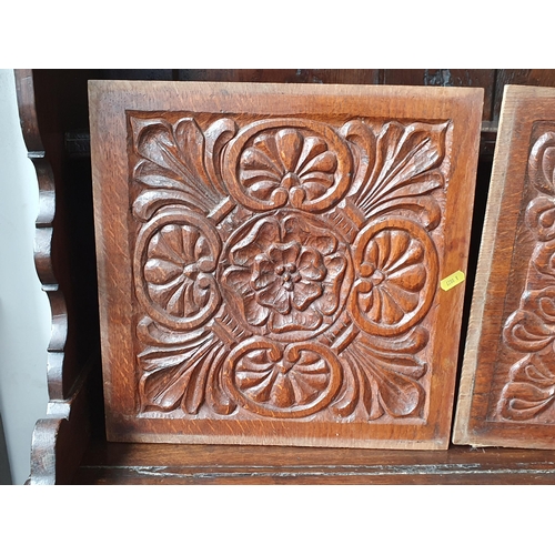 75 - Three antique oak Panels, two with carvings of rosettes and flowers and the other a religious bust f... 