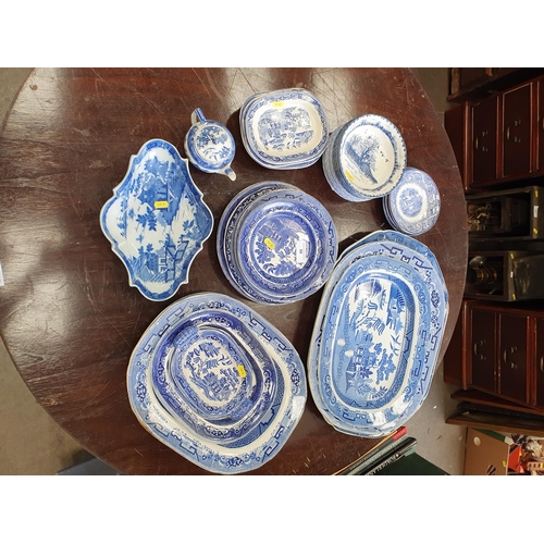 80 - A quantity of blue and white china including Willow pattern Meat Plates, Dinner Plates, Stands, Wedg... 