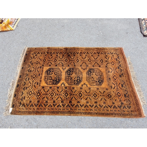 830 - A yellow ground Rug with multiple geometric borders with three stylised central motifs, 6ft 6