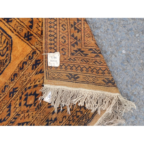 830 - A yellow ground Rug with multiple geometric borders with three stylised central motifs, 6ft 6