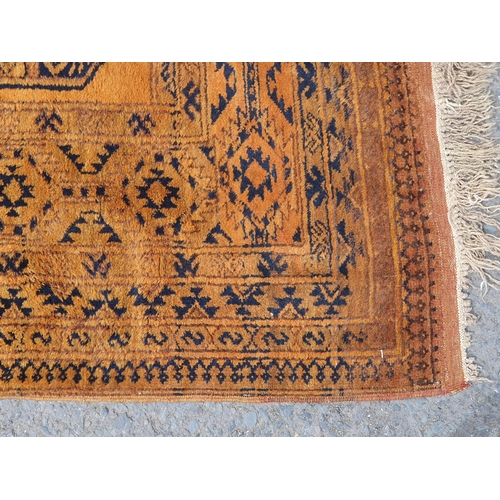 830 - A yellow ground Rug with multiple geometric borders with three stylised central motifs, 6ft 6