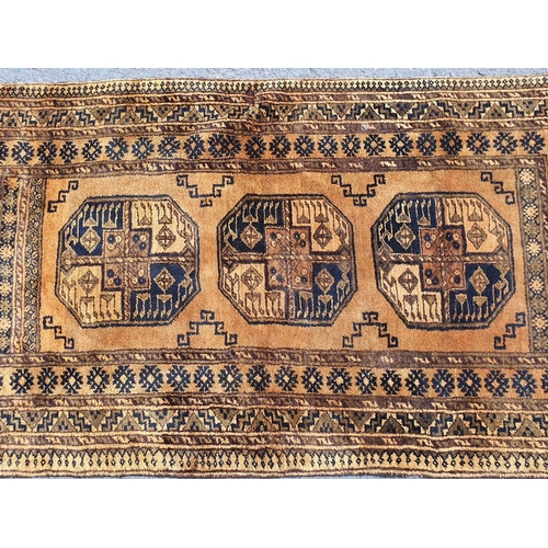 831 - A yellow ground Rug with multiple geometric borders, with three central octagonal motifs, 6ft 9