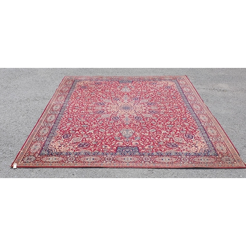 832 - A red ground Persian style Carpet, with multiple floral borders, with large central motif surrounded... 