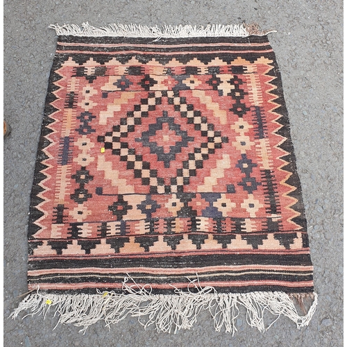 833 - A small brown and red ground Rug with central diamond pattern, 3ft 5in x 3ft