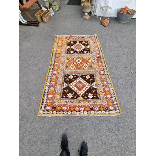 828 - A yellow and beige ground Carpet with multiple floral borders with three rectangular geometric centr... 