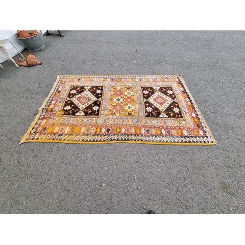 828 - A yellow and beige ground Carpet with multiple floral borders with three rectangular geometric centr... 