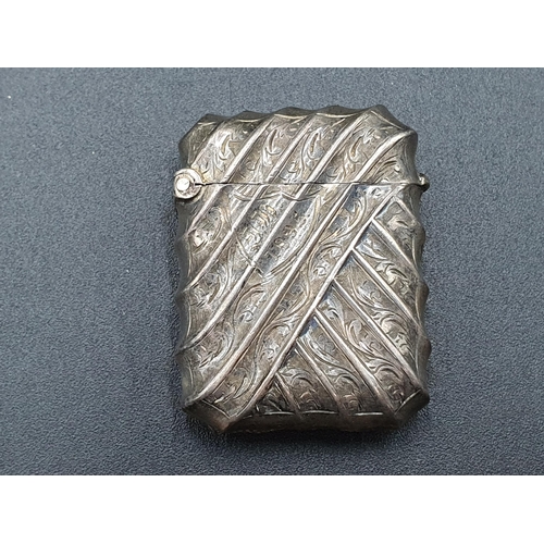 103 - A Victorian silver Vesta Case spirally fluted and engraved, Birmingham 1894, a Cigarette Holder in c... 