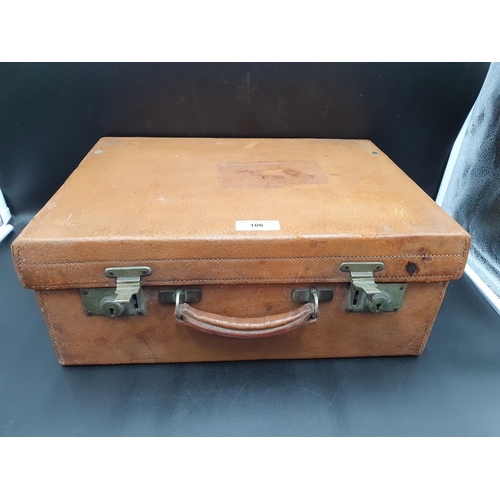 106 - A George V leather Vanity Case containing numerous silver mounted fittings including brushes and mir... 