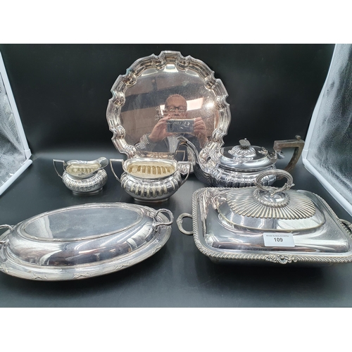 109 - A plated three piece Tea Service of fluted boat shape, an EP oblong Entree Dish and Cover with gadro... 