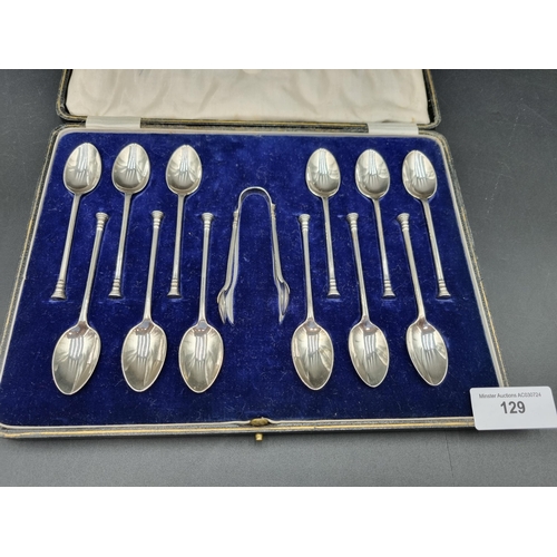 129 - One dozen George V silver seal top Teaspoons and Sugar Tongs, Sheffield 1925, in case