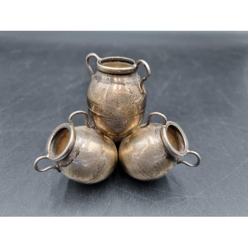 133 - An Eastern silver Posy Holder in the form of four amphora, 2 1/2in