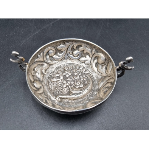 134 - A Continental silver Quaich with floral and leafage scroll embossing, pierced bird handles, 4in